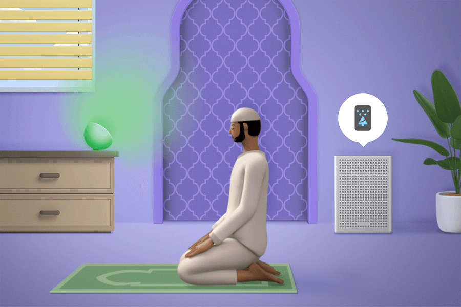 Un homme prie pendant que les stores, les lumières et le purificateur d'air créent un environnement optimal.